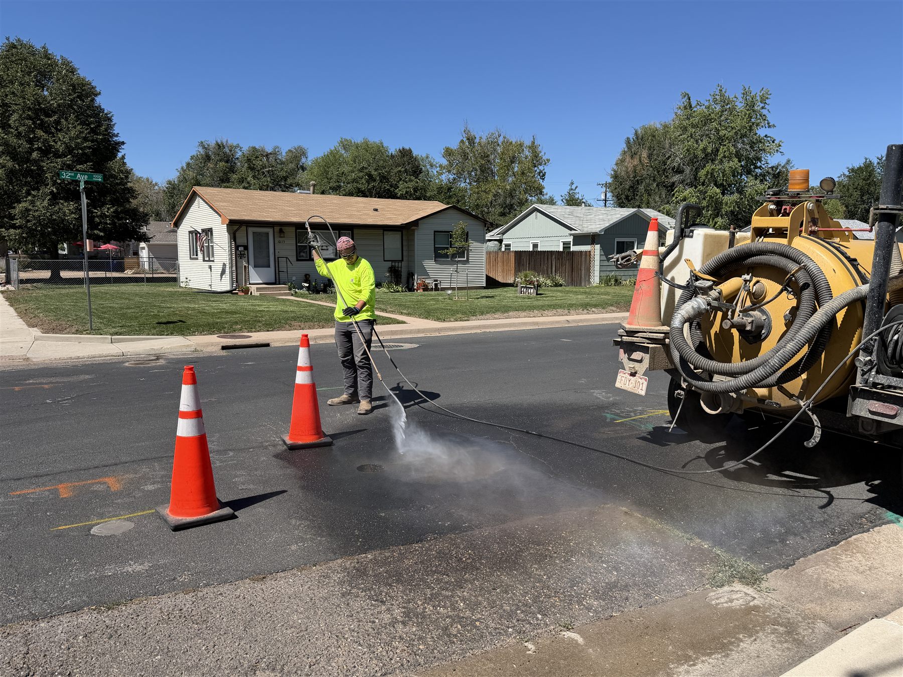 Crew washing asphalt after potholing