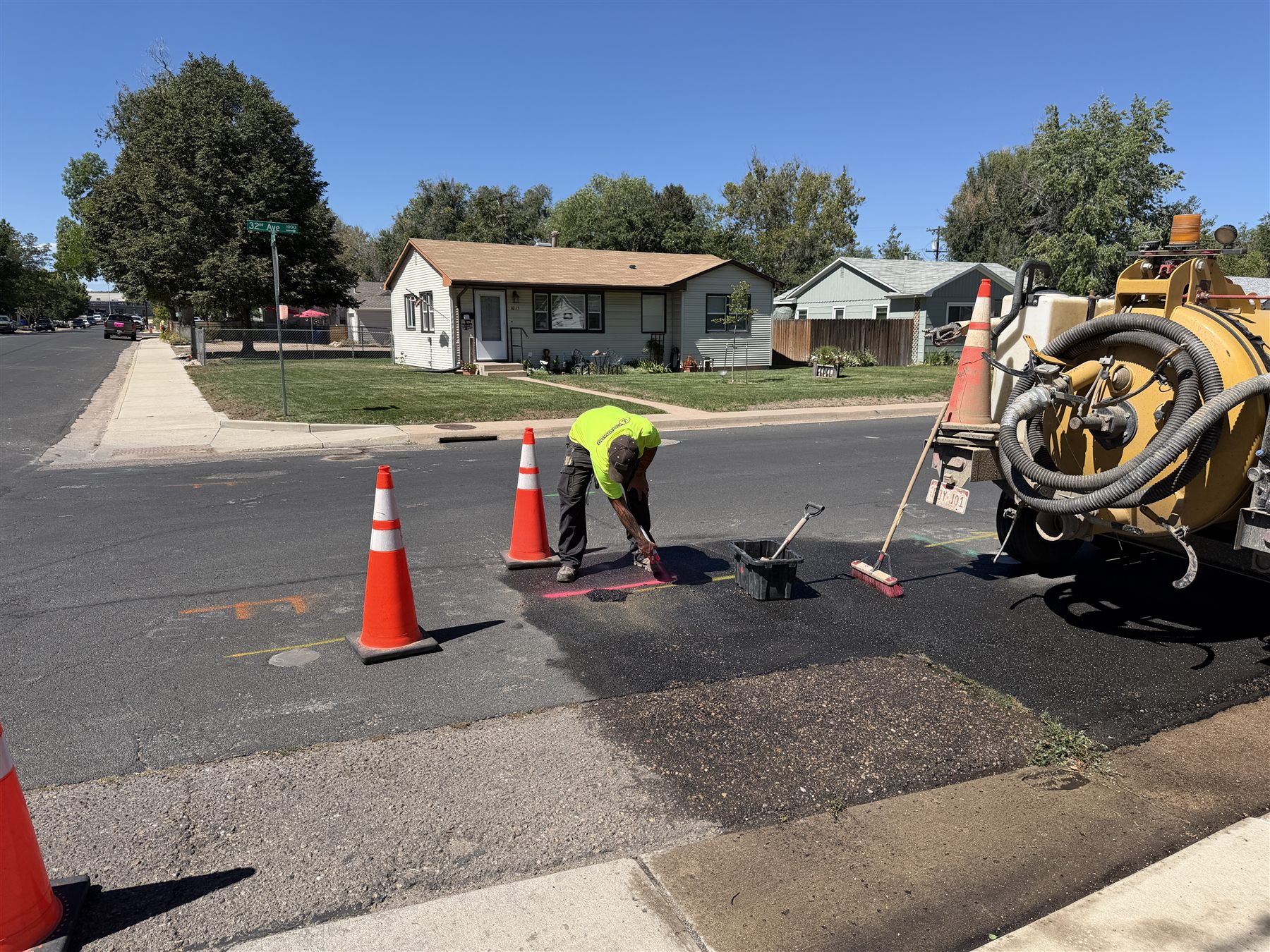 Crew painting utility marks on the street after potholing